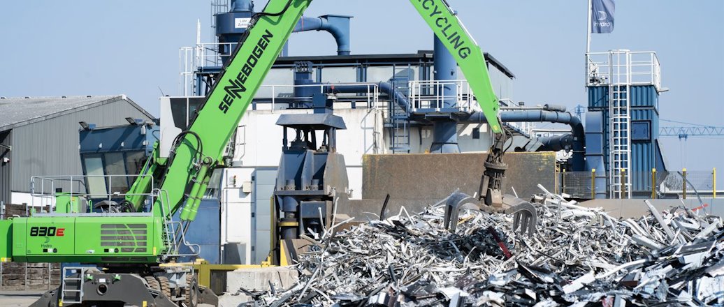 a crane lifting a pile of garbage