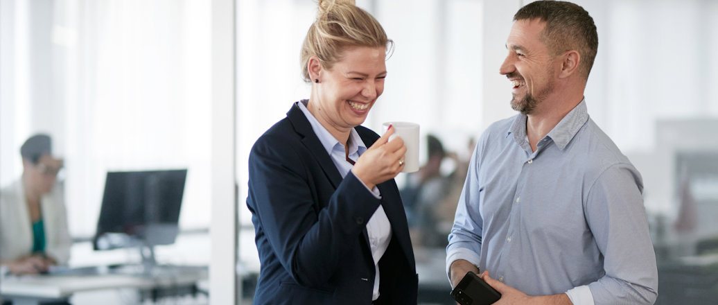a man and a woman looking at a tablet