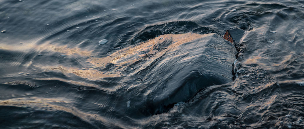 Water flowing over a rock