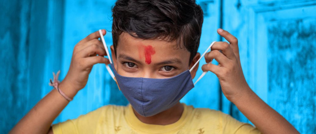 Child putting on a face mask