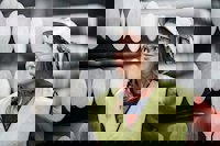 Hydro employee in front of aluminium billets