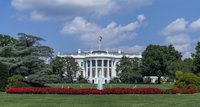 a white house with a flag on top with White House in the background