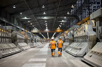 two people in safety vests in a factory