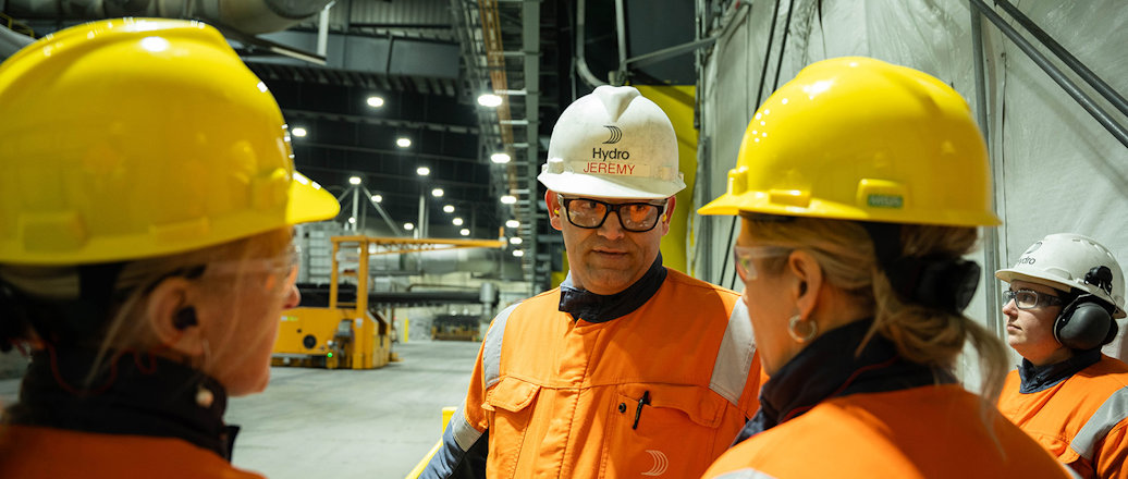 a group of people wearing hardhats and reflective clothing