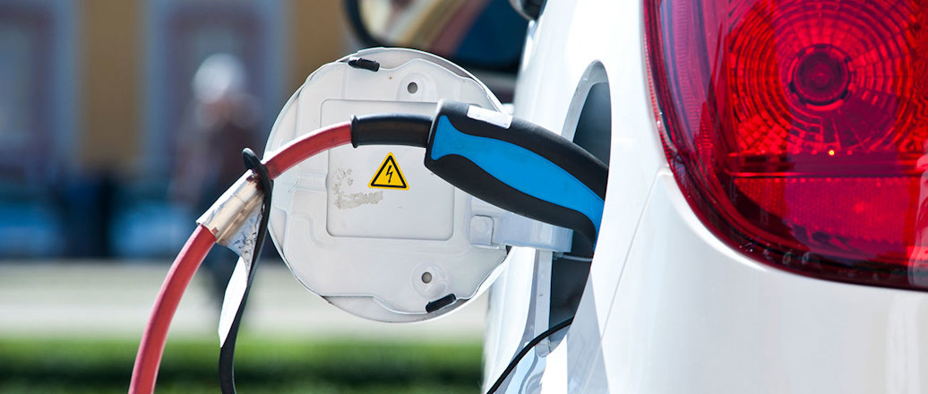 a close-up of a white car with a red light