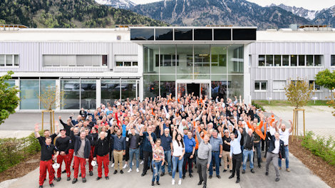 a group of people posing for a photo outside of a building