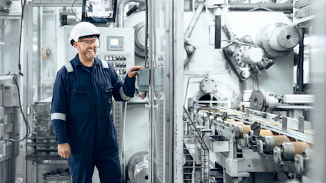 a man in a hard hat working in a factory