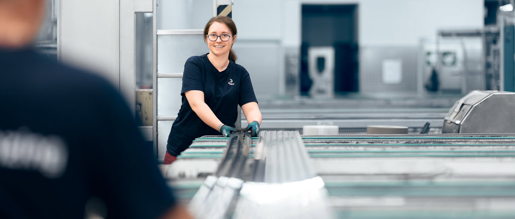a woman and a man working in the packaging area