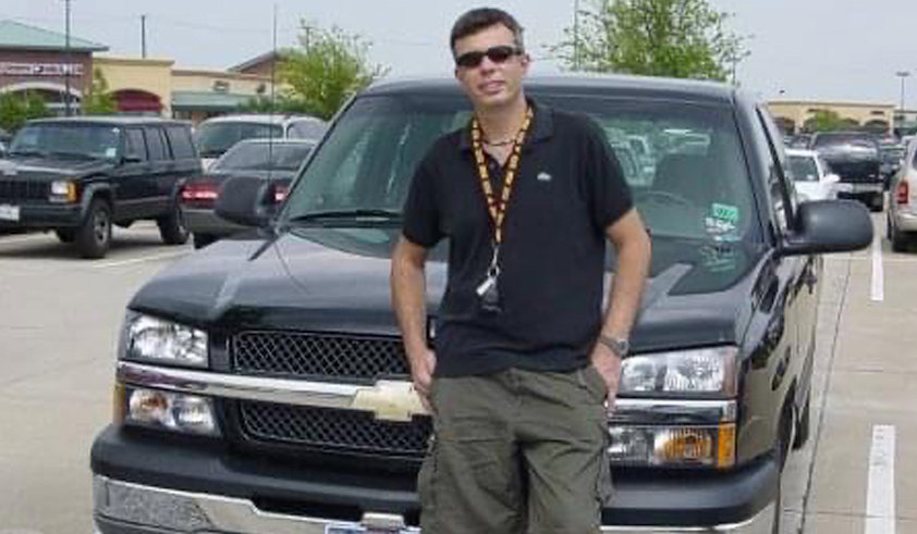 a man standing next to a car