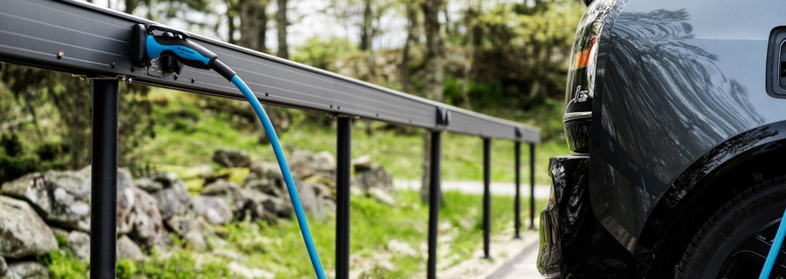 a car parked next to a fence